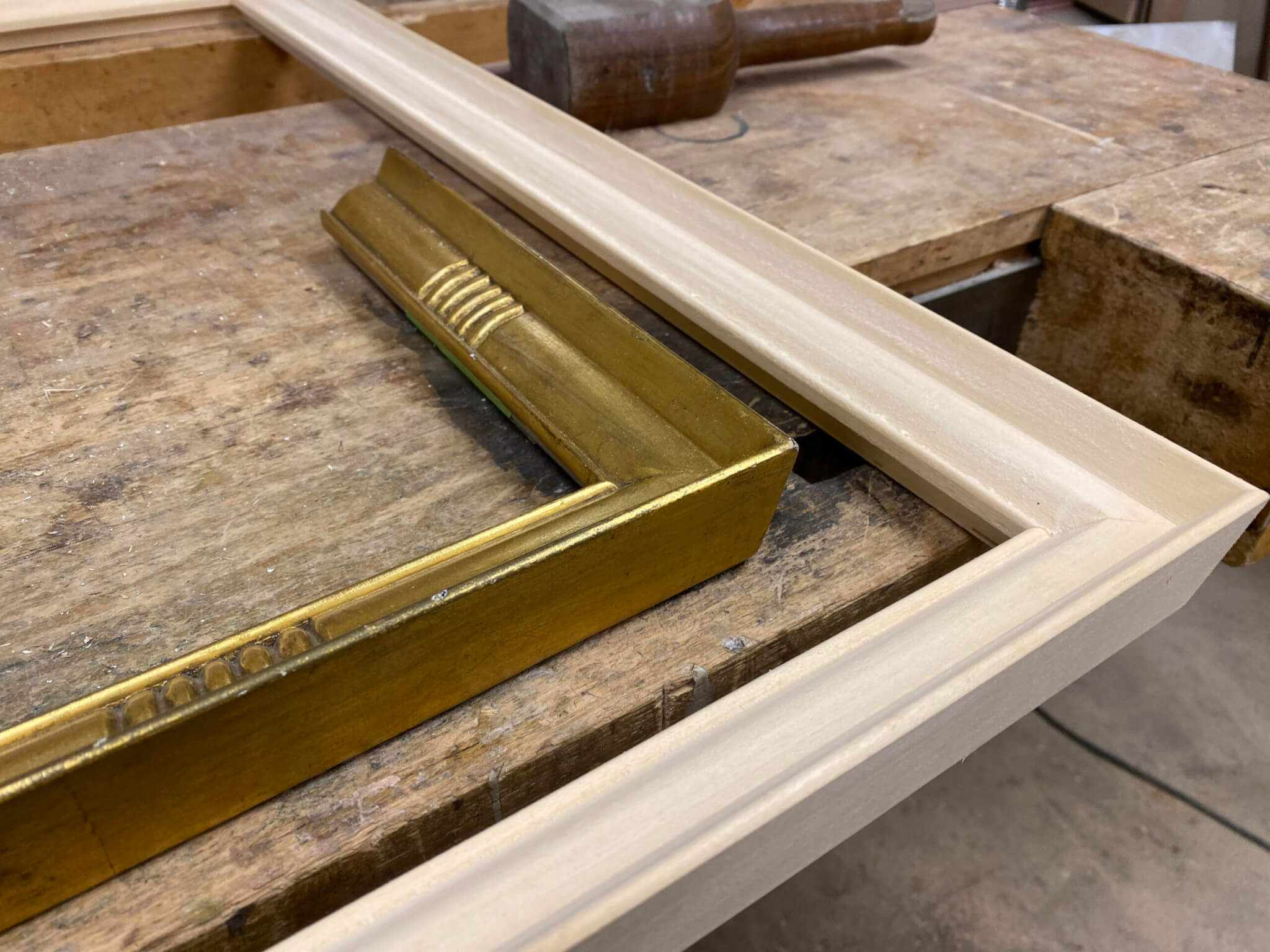 Types of custom picture frames-2 frames on a Chicago work bench in progress