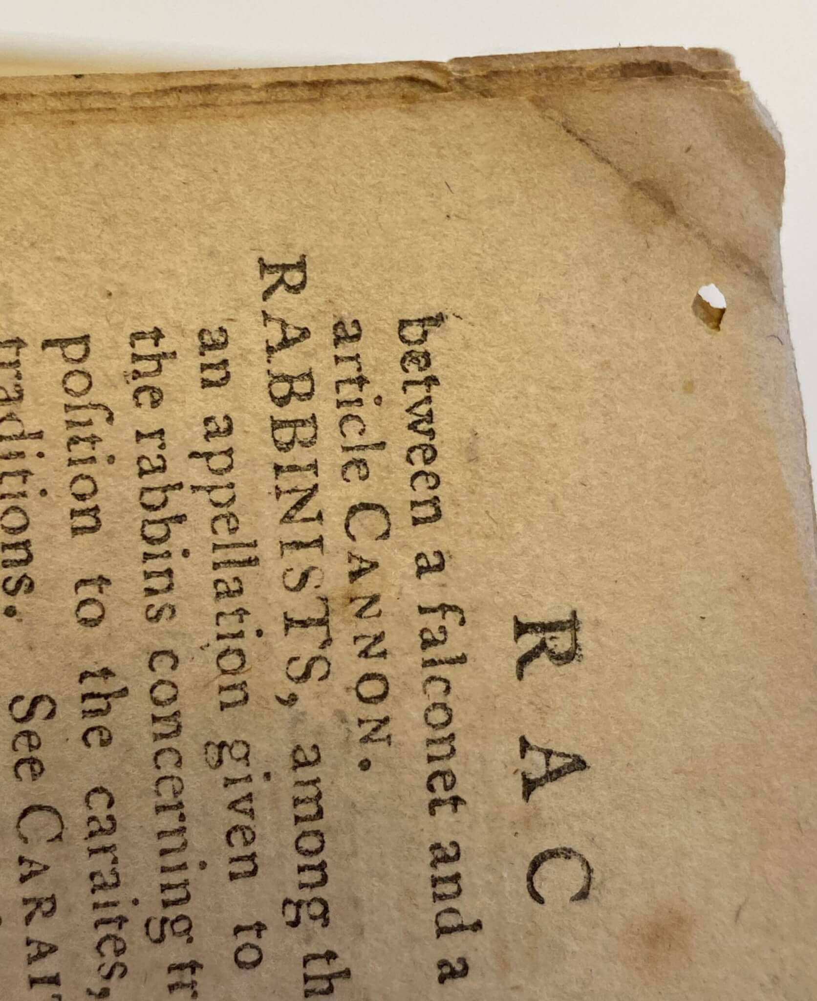 hole created in a textblock in an antique book, insect damage, book conservation chicago