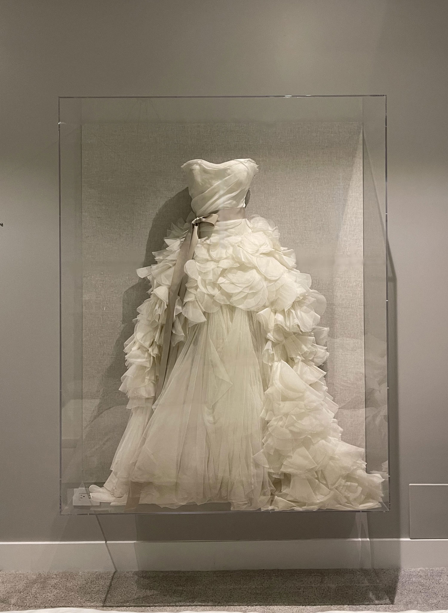 A Vera Wang wedding gown displayed in a custom vitrine