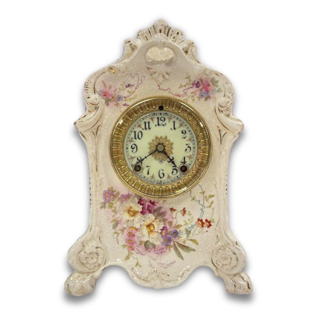 A conserved and restored porcelain case mantel clock with hand painted flowers