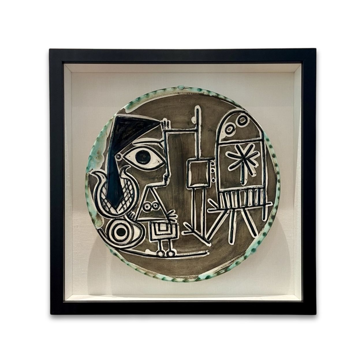 A ceramic Pablo Picasso charger-platter displayed in a custom made shadowbox