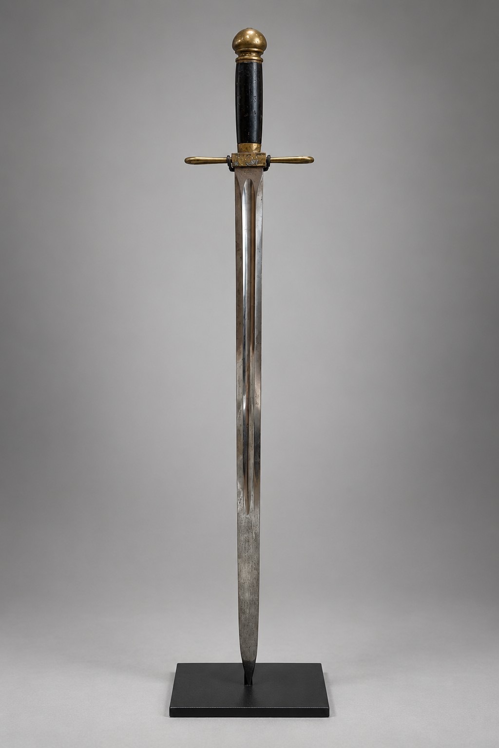 1893 Columbian Exposition guard's sword displayed upright on a custom black powder-coated steel stand, front view.