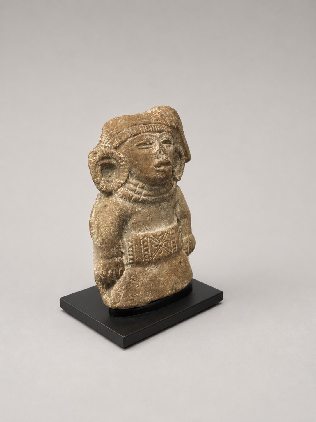 Pre-Columbian stone sculpture on a custom mount, viewed from the front left angle