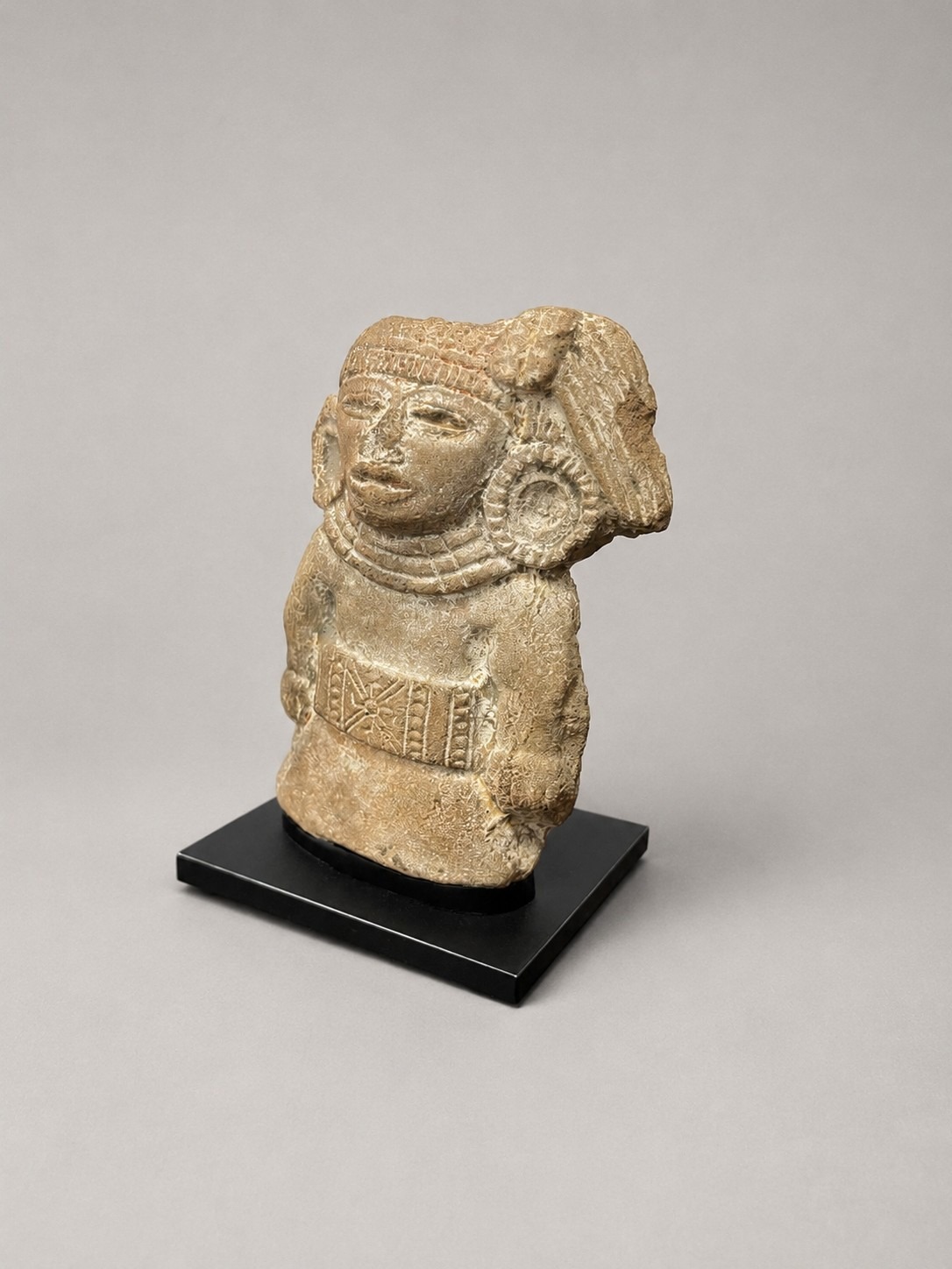 Pre-Columbian stone sculpture on a custom mount, viewed from the front right angle