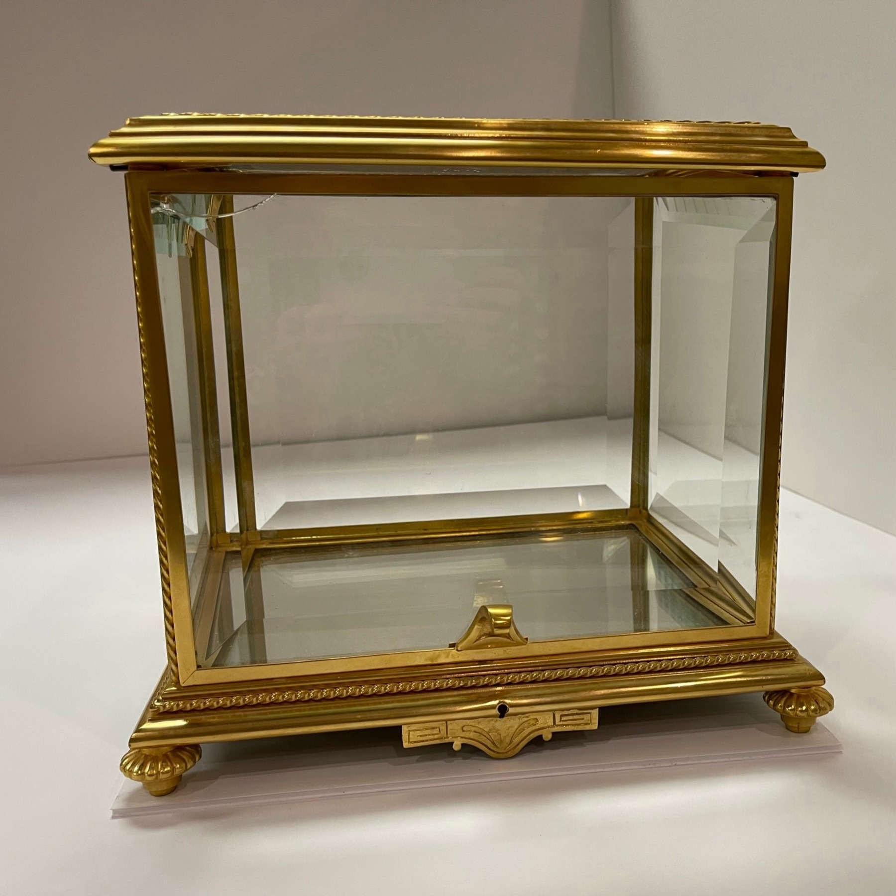 Antique brass tantalus with broken beveled glass panel, three-quarter view before restoration