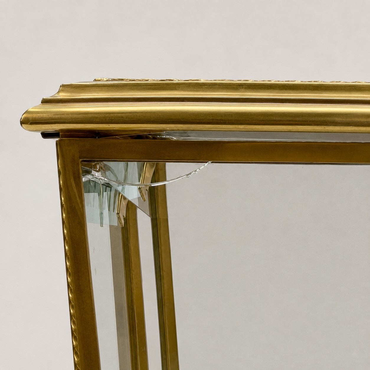 Close-up of the broken beveled glass panel corner on the antique tantalus, alternate crop