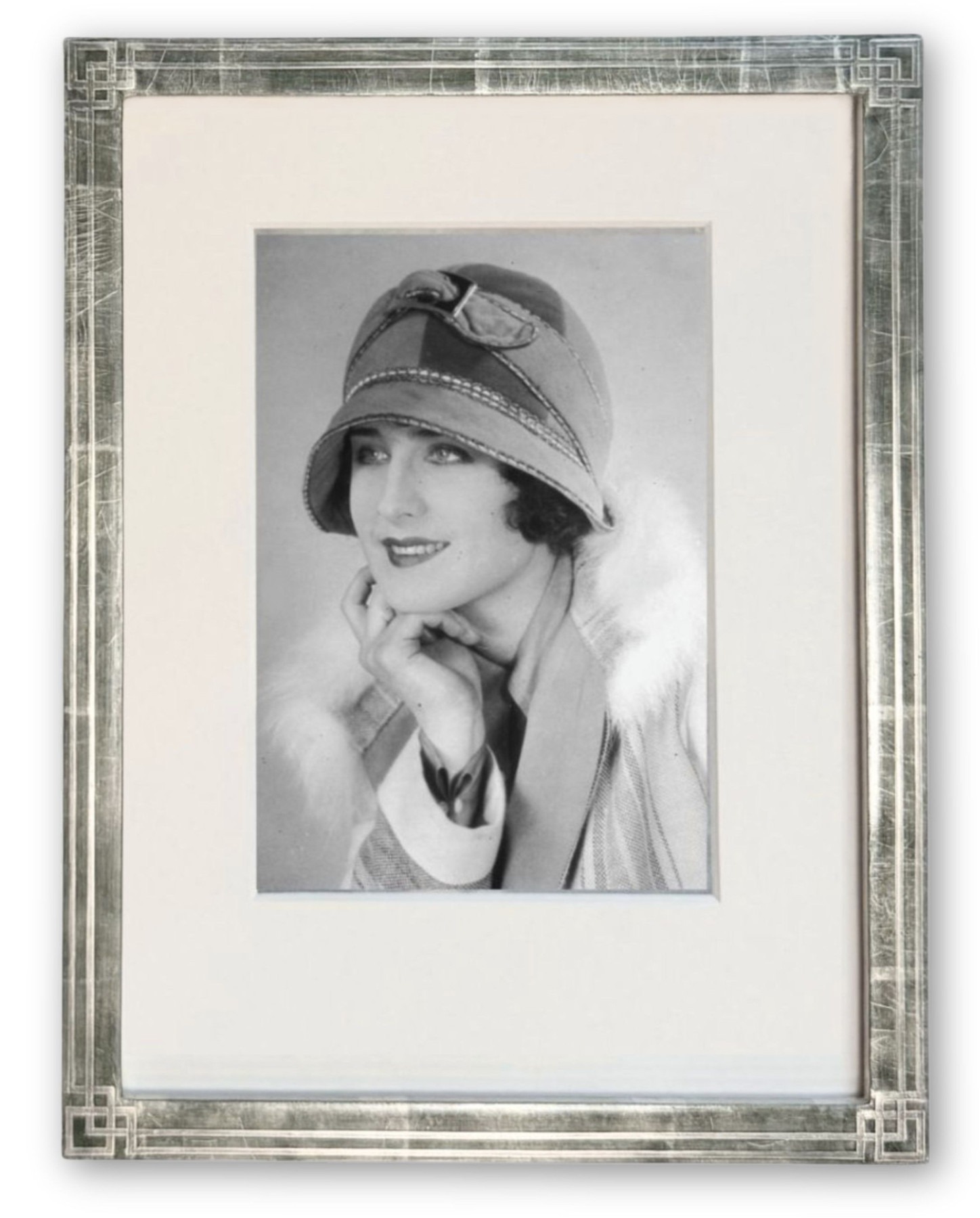 Art Deco frame in white gold leaf with a cream mat holding a 1920s black-and-white gelatin silver print portrait of a woman in a cloche hat