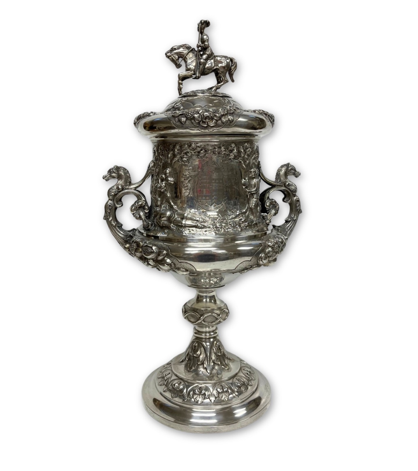 Restored antique silver trophy cup with equestrian finial and coat of arms following fire damage treatment